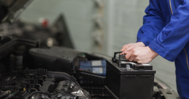 Automechanik měnící autobaterii v servisu.